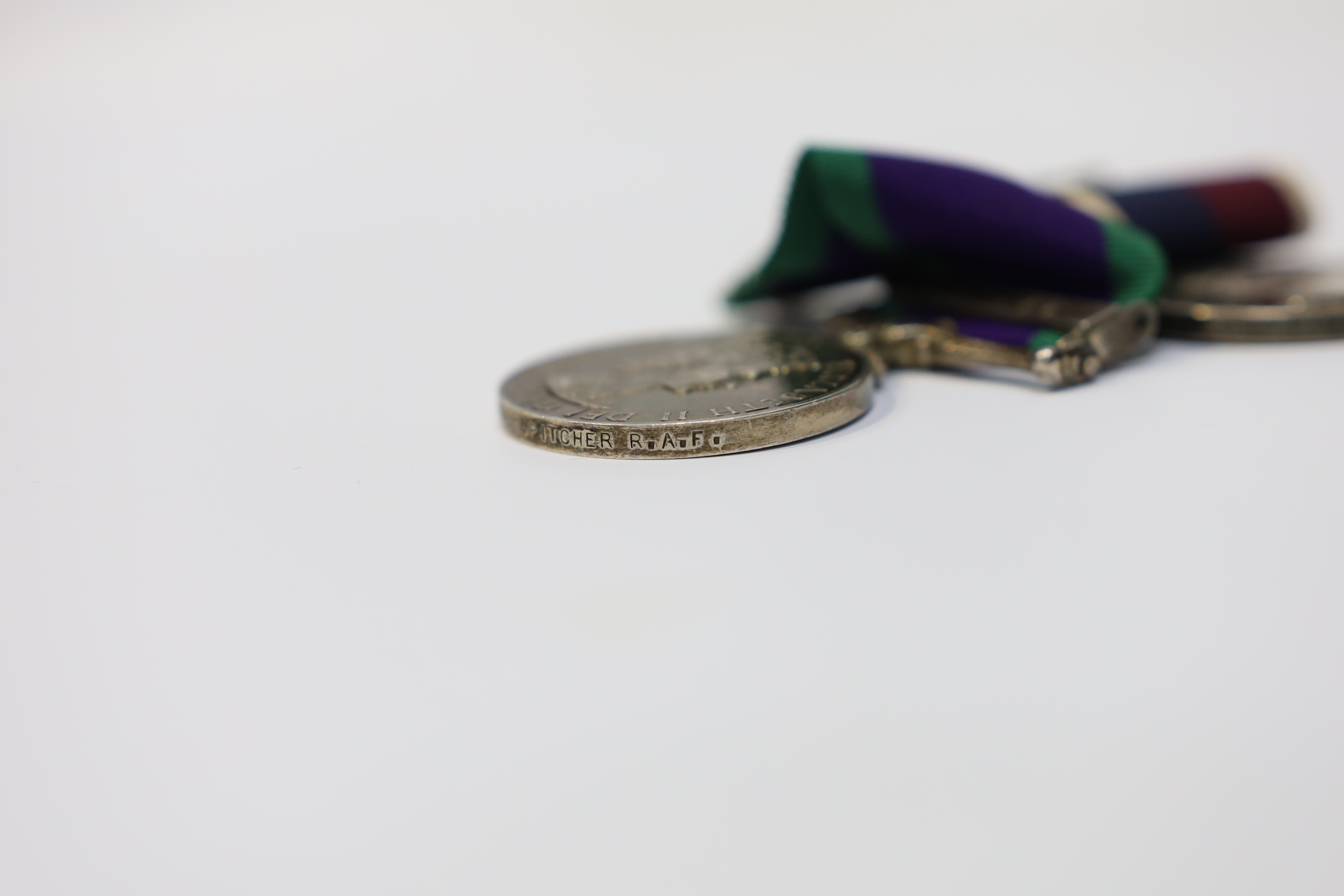 An ERII RAF medal pair awarded to Cpl. A.F.G. Pitcher RAF, comprising; a General Service Medal with a bar for Borneo and an RAF Long Service Medal, mounted on a common pin. Condition - fair to good